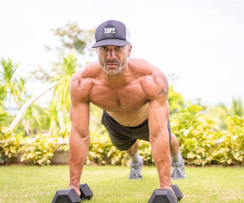 Tuff Supps photo of man on dumbells with hat on