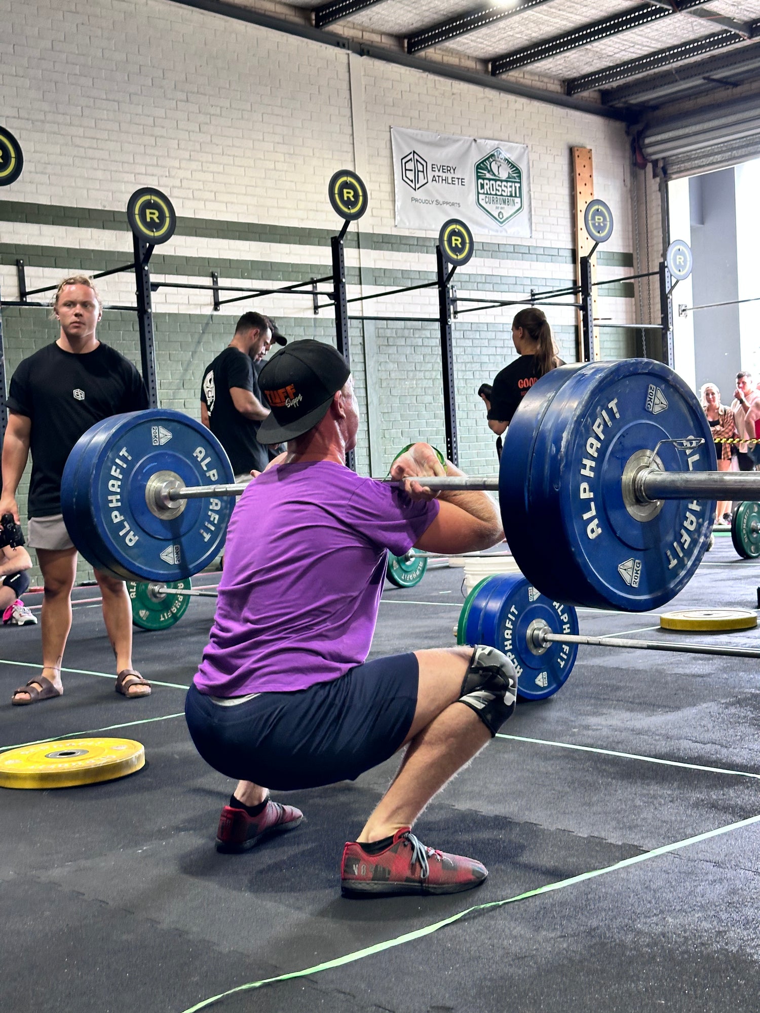 Photo of weightlifter with Tuff Supps hat on